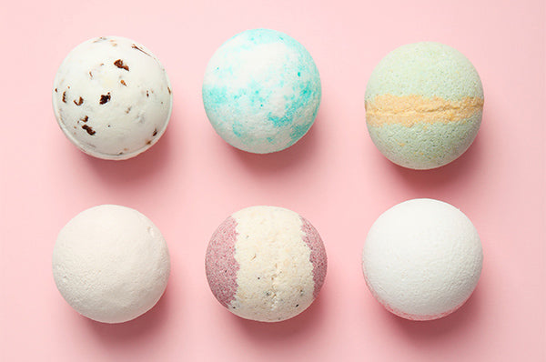 Images of Six Bath Bombs on Pink Background