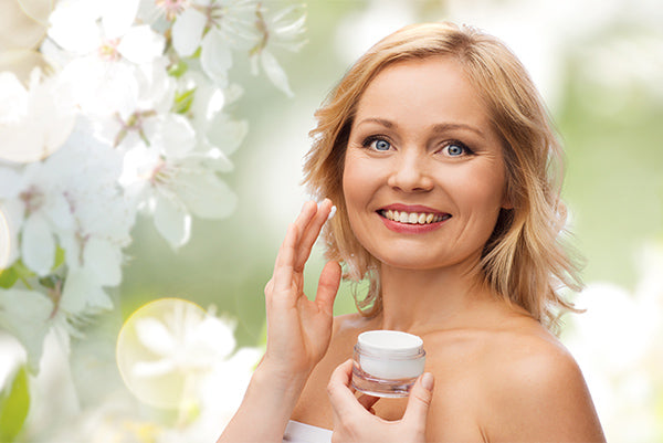 Image o a woman holding a jar of daily moisturiser