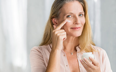 Image of Mature Woman Applying Cleansing Face Cream