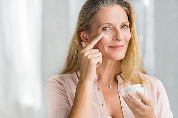 Image of Mature Woman Applying Cleansing Face Cream