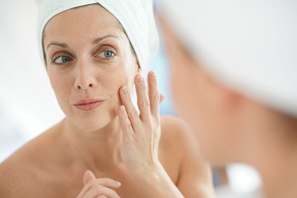 Image of Mature Woman applying Mullein Face Lifting Oil on her Face as part of her Skincare Routine