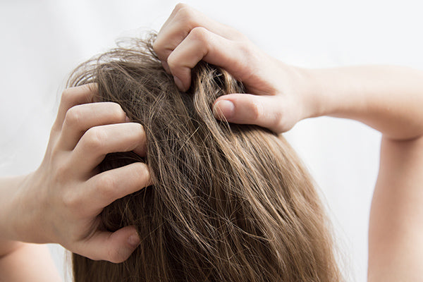 Image of Woman Scratching her Scalp suitable for Scalp Serum