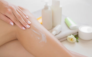 Image of woman applying ultra smooth silk balm on her body / legs