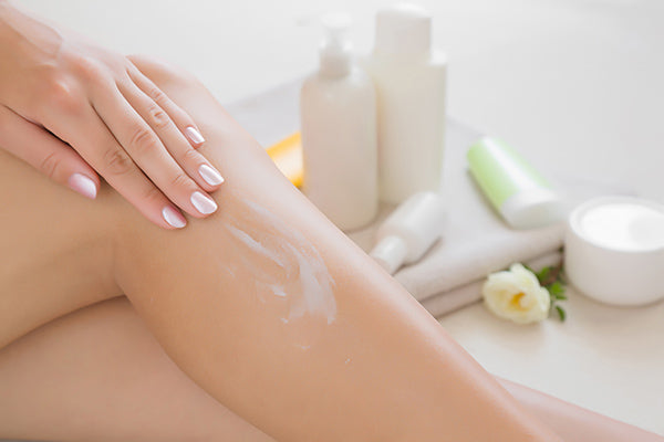 Image of woman applying ultra smooth silk balm on her body / legs