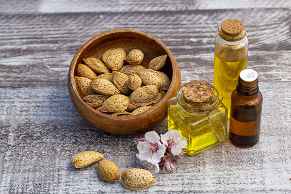 Images of almond seed and Sweet almond oil for stretch mark oil