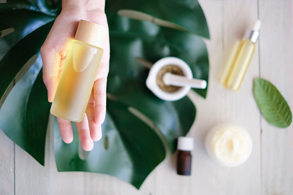 Image of a Person holding a bottle of Vitamin Bath and Spa Products