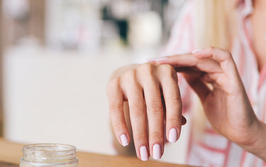 image of someone applying hand cream to reduce age spots on hands