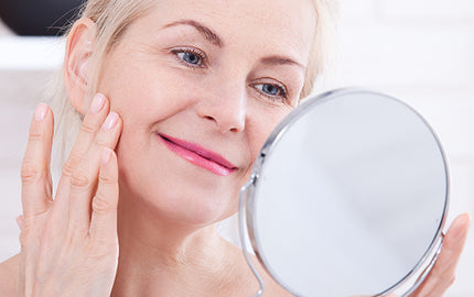 image of mature woman applying anti wrinkle facial serum with prickly pear