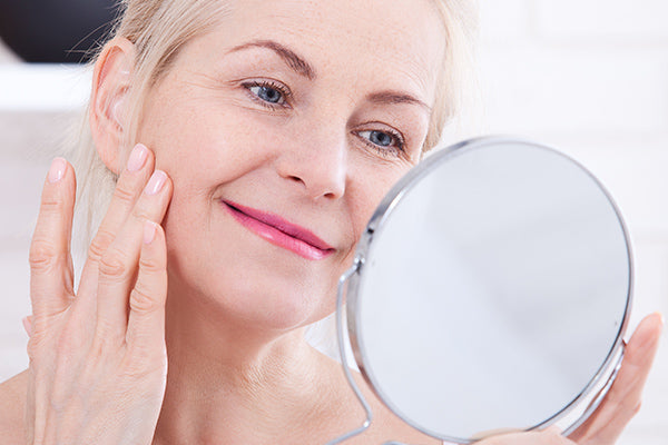image of mature woman applying anti wrinkle facial serum with prickly pear