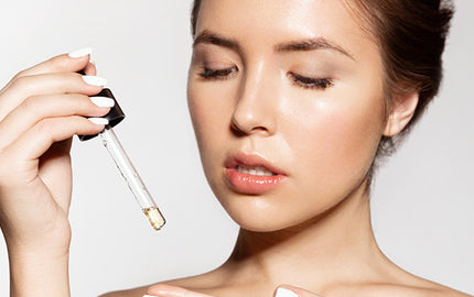 image of a woman using the facial serum with argan oil