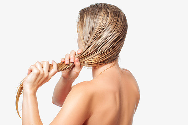 Image of woman doing a hair mask using organ hair conditioner