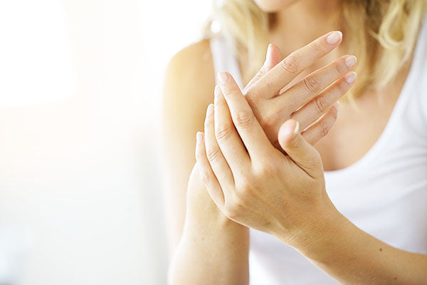 image of woman using calendula hand cream