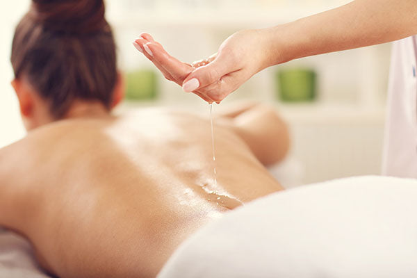 image of massage being done with chickweed and chamomile massage oil