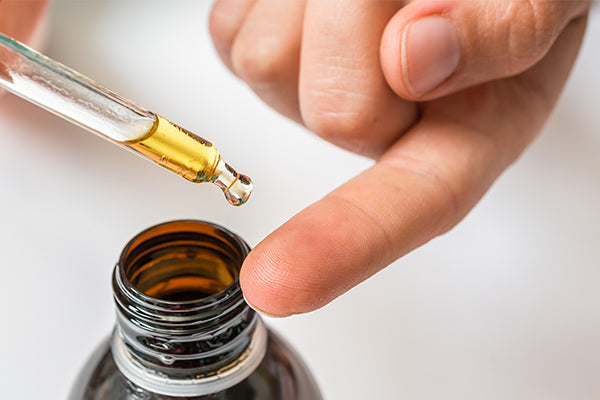 image of someone applying hemp seed cuticle cure oil