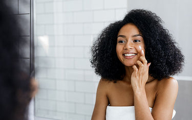 image of a woman applying daily moisturising cream