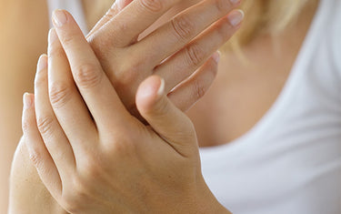 image of a woman using the everyday hand cream