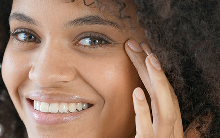 image of a woman using eye serum for daily use