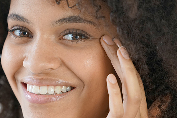 image of a woman using eye serum for daily use