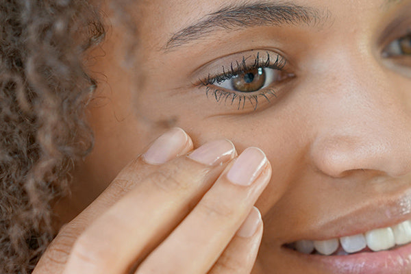 image of a woman applying rich eye cream