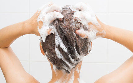 Image of woman using gentle shampoo in the shower