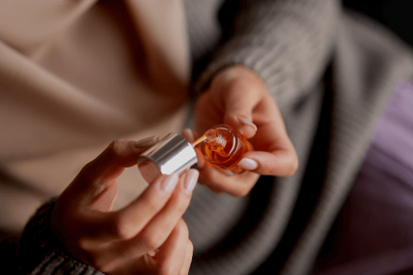 image of someone using the nail oil blend 