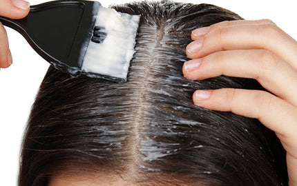 image of woman applying watermelon and mango hair conditioner on her roots