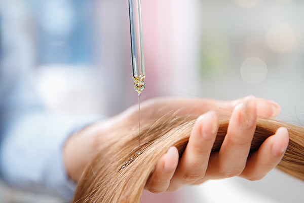 image of someone applying conditioning herbal hair pack