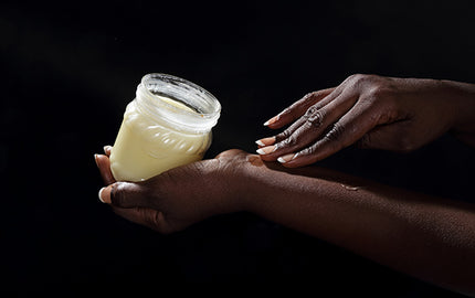 Image of a woman applying intensive night cream at night