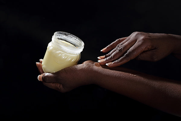 Image of a woman applying intensive night cream at night