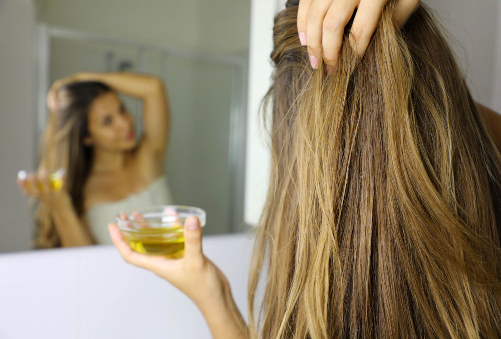 applying almond oil to hair