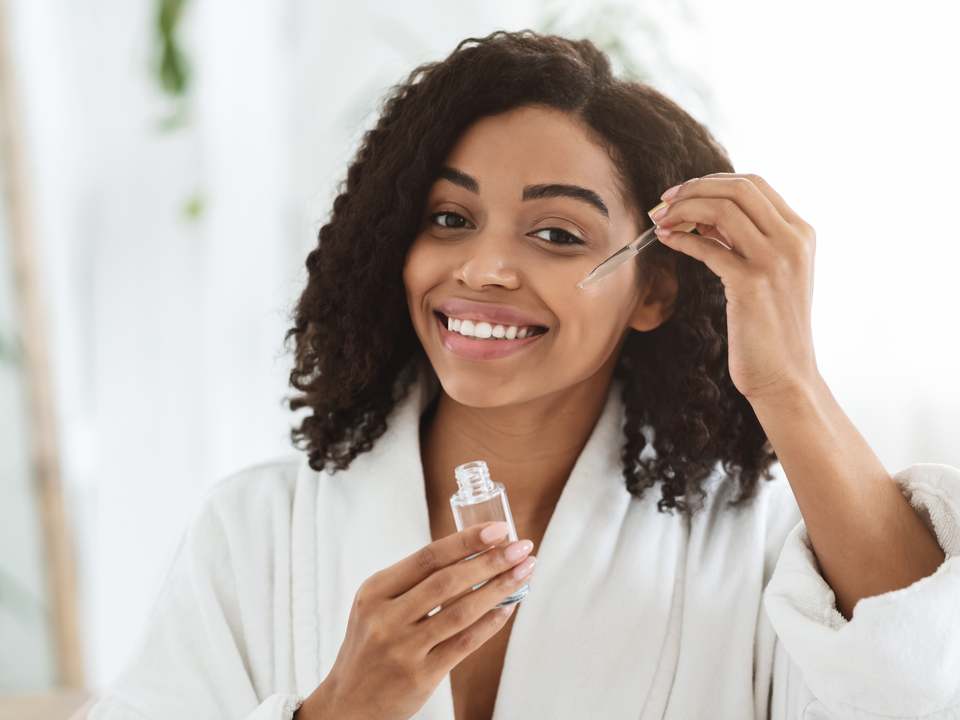 Woman Applying Hydrating Face Serum