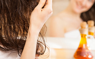 image of woman using simple spray hair tonic